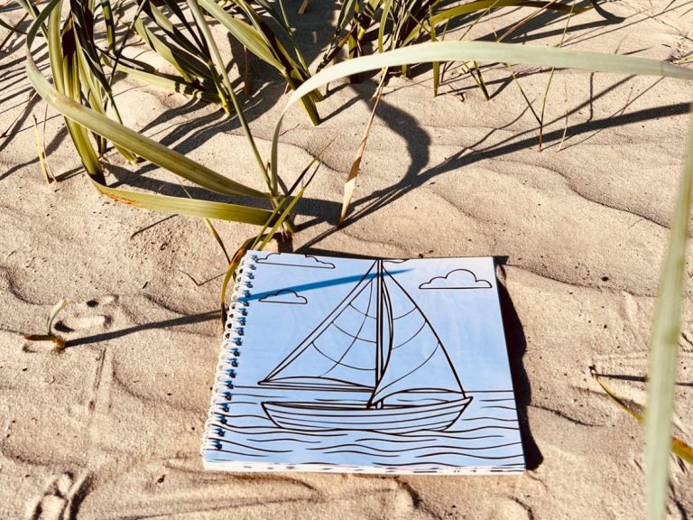 Unterschiedliche Motive für verschiedene Stimmungen und Menschen - ein Malbuch für alle und zum teilen - der perfekte Urlaubsspaß ohne Bildschirm Beispielseite mit einem Segelboot am Strand aus dem generationsübergreifenden Ausmalbuch mit Reisethemen